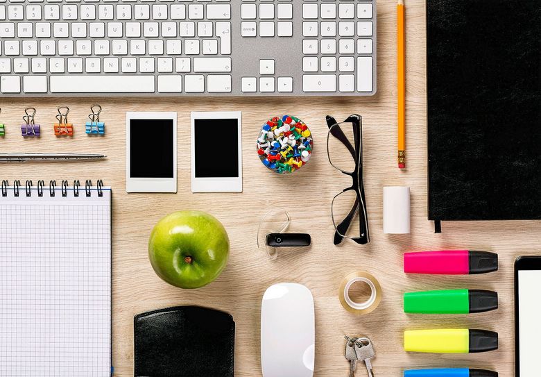 Top of desk with office equipment arranged if perfect order.